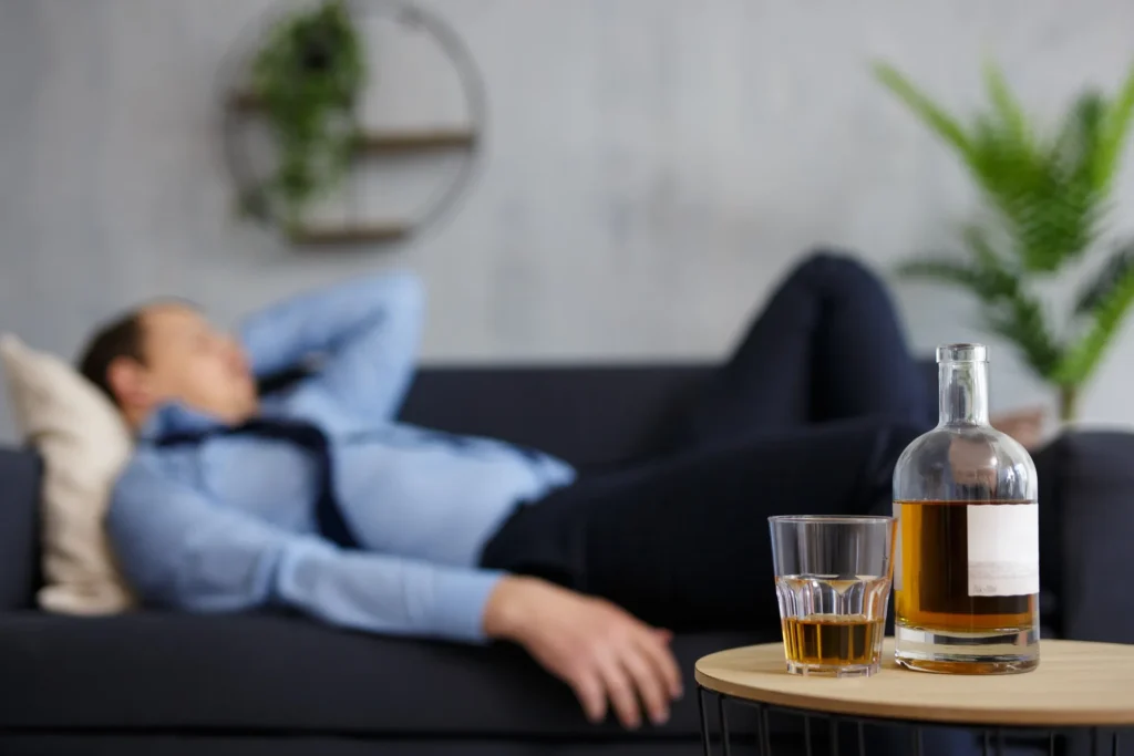A man abusing alcohol and is passed out on the couch; requires treatment here at The Encino Detox; call us. 