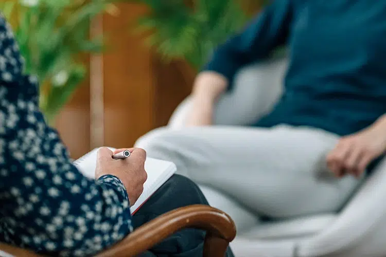 A person participates in therapy for dual diagnosis treatment.